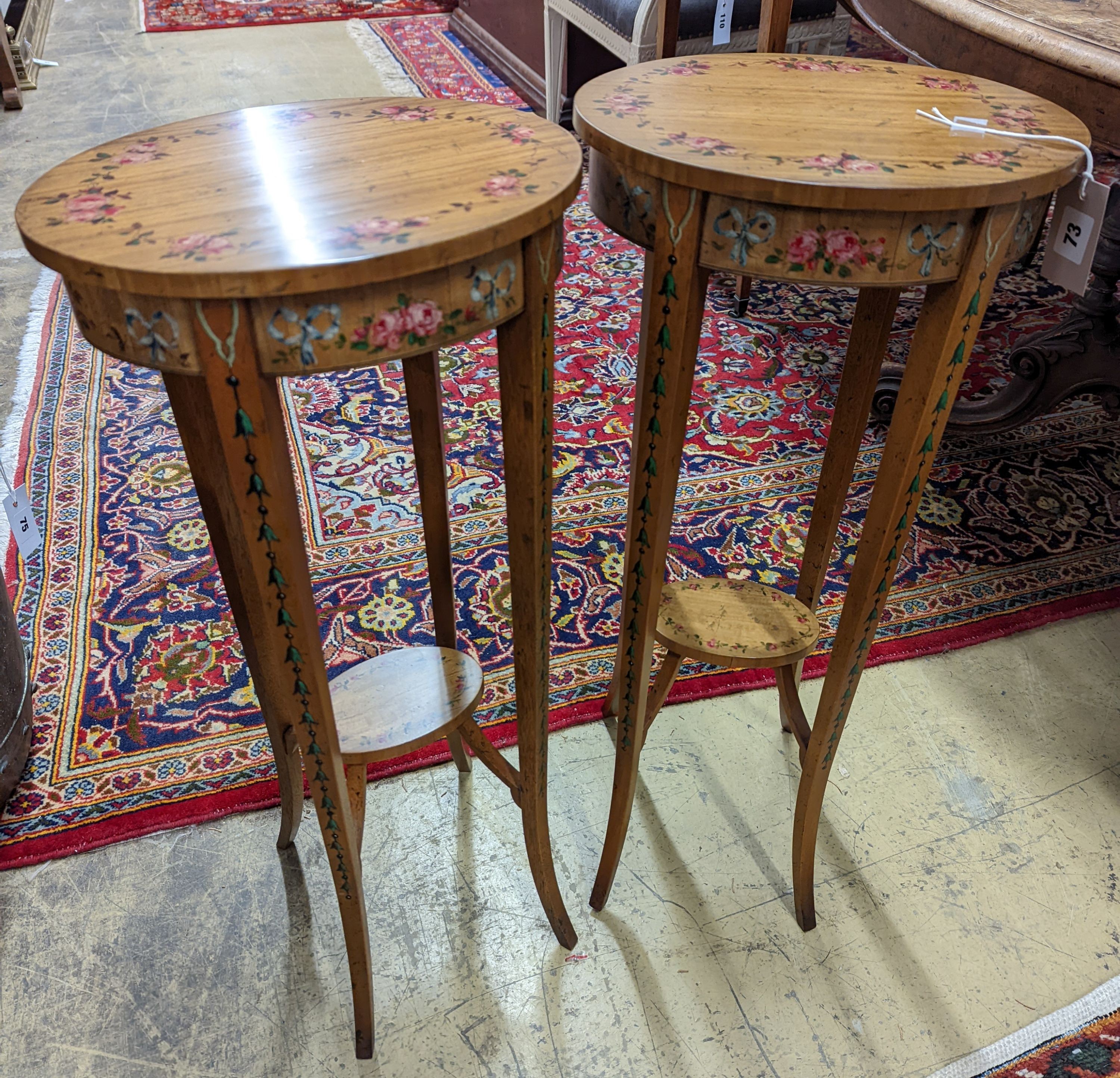 A pair of Sheraton style oval painted satinwood occasional tables, width 31cm, depth 26cm, height 71cm